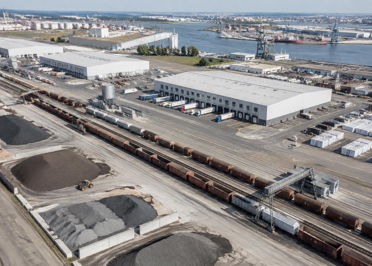 Aerial view of a rail-linked back-of-port warehouse and stockpile terminal